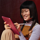A person writing on the 10th generation iPad using the first generation Apple Pencil.